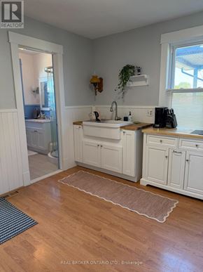 Wainfleet (Lakeshore) apartment for rent - A kitchen with white cabinets and a wooden floor.