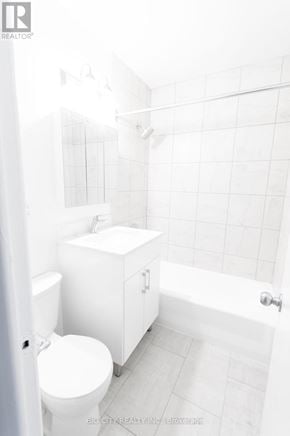 Toronto (St. Andrew-Windfields) condo for rent - A white bathroom with a toilet, sink and bathtub.