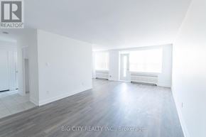 Toronto (St. Andrew-Windfields) condo for rent - A spacious room with white walls and wooden flooring.