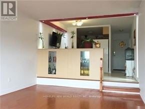 Toronto (Agincourt South-Malvern West) condo for rent - A room with a wooden floor and a mirror on the wall.