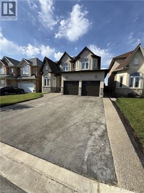 Hamilton apartment for rent - A large house with a driveway in front of it.