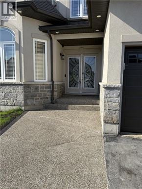 Hamilton apartment for rent - A house with a stone wall and a black door.