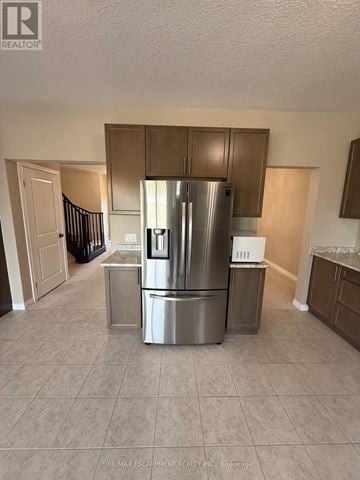 Hamilton apartment for rent - A kitchen with a stainless steel refrigerator and cabinets.