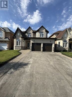 Hamilton apartment for rent - A large house with a driveway in front of it.