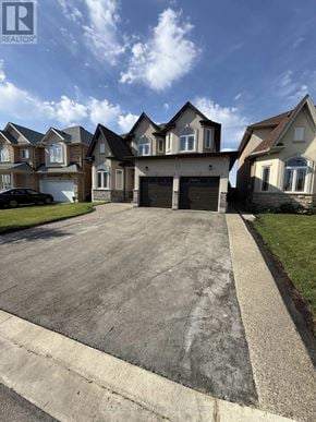 Hamilton apartment for rent - A large house with a driveway in front of it.