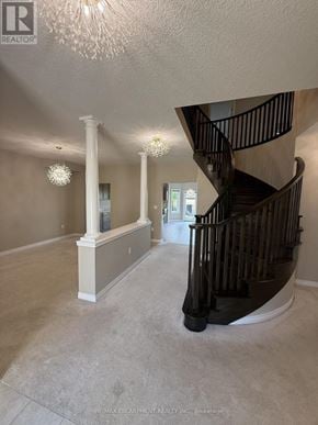 Hamilton apartment for rent - A spacious room with a staircase and a chandelier.