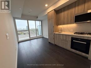 Toronto (Bayview Village) condo for rent - A kitchen with wooden cabinets and a black oven.