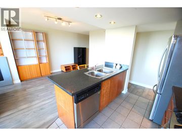 Richmond apartment for rent - A kitchen with a wooden island and stainless steel appliances.