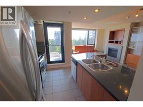 Richmond apartment for rent - A kitchen with a refrigerator, sink, and a window.