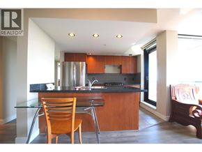 Richmond apartment for rent - A modern kitchen with a wooden chair and a glass table.