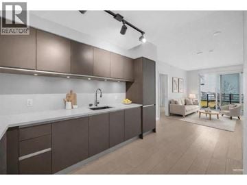Vancouver apartment for rent - A modern kitchen with brown cabinets and a white countertop.