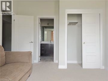 Hamilton townhouse for rent - A living room with a couch and a doorway leading to a kitchen.