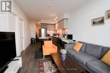 Vaughan (Beverley Glen) condo for rent - A living room with a grey couch and a coffee table.