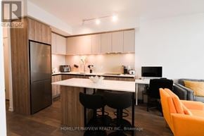Vaughan (Beverley Glen) condo for rent - A modern kitchen with a white countertop and a black fridge.