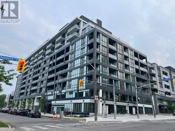 Toronto (Bayview Village) condo for rent - A large, modern building with many windows and a sign that reads "HomeLife New World REALTOR INC.".