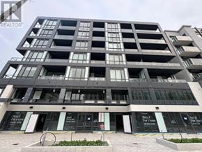 Toronto (Bayview Village) condo for rent - A modern multi-story building with a sign that reads "For Lease".
