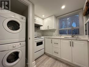 Toronto (Caledonia-Fairbank) apartment for rent - A white washing machine is in a laundry room.