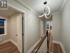 Toronto (Caledonia-Fairbank) apartment for rent - A hallway with a wooden floor and a chandelier hanging from the ceiling.