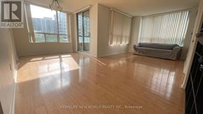 Toronto (Willowdale East) condo for rent - A spacious living room with wooden flooring and large windows.