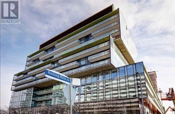 Toronto (Waterfront Communities) condo for rent - Rolling Mills 10 is a modern building with a glass facade and a green roof.