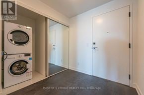 Toronto (Waterfront Communities) condo for rent - A laundry room with a washer and dryer.