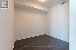 Toronto (Waterfront Communities) condo for rent - A white room with a wooden floor and a wall with a small vent.