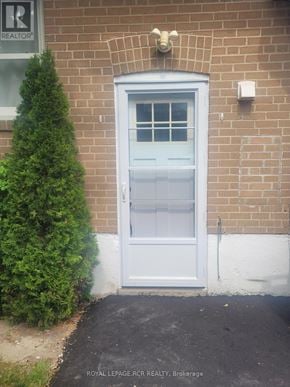 Newmarket (Bristol-London) apartment for rent - A white door with a glass window is on a brick building.