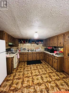 Richmond Hill (Crosby) apartment for rent - A kitchen with wooden cabinets and a patterned carpet.