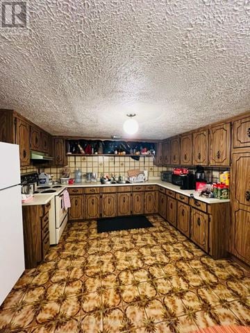 Richmond Hill (Crosby) apartment for rent - A kitchen with wooden cabinets and a patterned carpet.