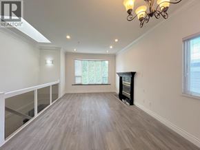 Vancouver apartment for rent - A well-lit, spacious room with a fireplace and a chandelier.