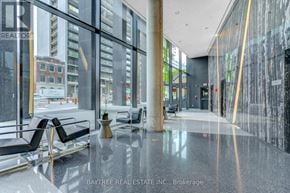 Toronto (Waterfront Communities) condo for rent - A Baytree Real Estate Inc. brokerage office with a glass wall and black chairs.