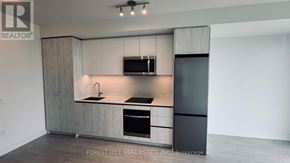 Toronto (Newtonbrook West) condo for rent - A modern kitchen with a sink, stove, and refrigerator.