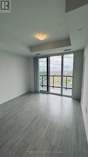 Toronto (Newtonbrook West) condo for rent - A spacious room with a view of the outdoors through a large window.