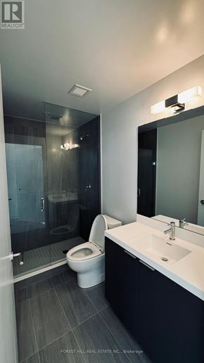 Toronto (Newtonbrook West) condo for rent - A modern bathroom with a toilet, sink, and mirror.