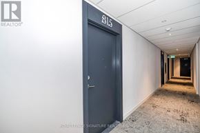 Toronto (Rouge) condo for rent - A hallway with a door numbered 815 and a brochure for Royal LePage Signature Realty.