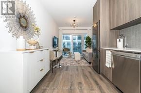 Toronto (Rouge) condo for rent - A modern kitchen with a large window and a dining area.