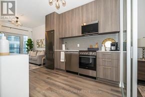 Toronto (Rouge) condo for rent - A modern kitchen with wooden cabinets and stainless steel appliances.