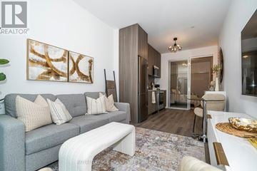 Toronto (Rouge) condo for rent - A living room with a grey couch and a painting on the wall.