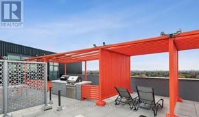 Toronto (Birchcliffe-Cliffside) condo for rent - A balcony with a grill and chairs under an orange pergola.