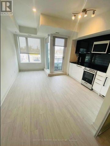Toronto (Birchcliffe-Cliffside) condo for rent - A kitchen with black countertops and white cabinets.