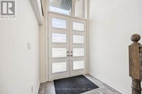 Vaughan (Patterson) townhouse for rent - A door with glass panels and a mat on the floor.