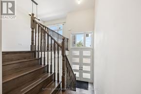Vaughan (Patterson) townhouse for rent - A staircase with a wooden banister and a white wall.
