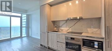 Vaughan (Vaughan Corporate Centre) condo for rent - A kitchen with a stove top oven and microwave.