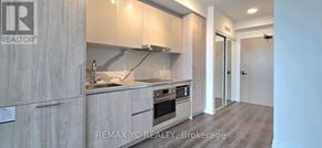 Vaughan (Vaughan Corporate Centre) condo for rent - A modern kitchen with a sink, stove, and cabinets.