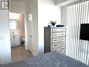 Mississauga (Central Erin Mills) condo for rent - A bedroom with a bed, dresser, and a window with blinds.