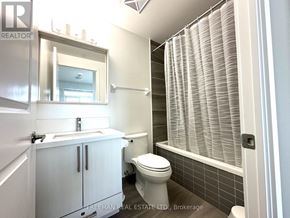Mississauga (Central Erin Mills) condo for rent - A white bathroom with a toilet, sink, and a window with blinds.