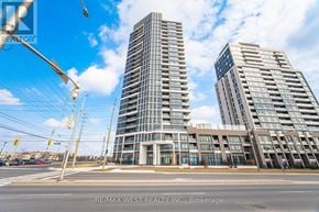 Milton (Co Coates) condo for rent - Two modern high-rise buildings are situated next to a street with traffic lights.