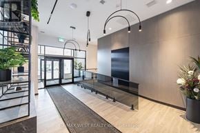Milton (Co Coates) condo for rent - A modern office lobby with a glass wall and a reception desk.