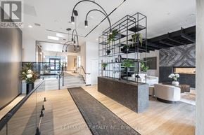 Milton (Co Coates) condo for rent - A modern interior space with a reception desk and hanging plants.
