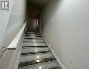 Brampton (Bram East) apartment for rent - A staircase with a metal railing and wooden steps.